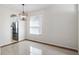 Bright dining room boasts tile floors, modern light fixture, and window with blinds at 13156 Hatherton Cir, Orlando, FL 32832