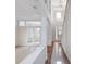 Bright foyer featuring tiled floors and wood accents, leading to a room with glass paneled doors and staircase at 13156 Hatherton Cir, Orlando, FL 32832