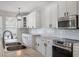 Kitchen features stainless steel appliances, granite countertops, white cabinets with black hardware at 13156 Hatherton Cir, Orlando, FL 32832