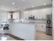 Kitchen with granite countertops, stainless steel appliances, white cabinets and modern light fixture at 13156 Hatherton Cir, Orlando, FL 32832
