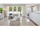 Open floor plan living room with lots of windows and natural light, tile floors, and modern decor at 13156 Hatherton Cir, Orlando, FL 32832