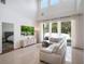 Bright living room features large windows, high ceilings, tile flooring, and a comfortable sectional sofa at 13156 Hatherton Cir, Orlando, FL 32832