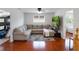 Cozy living room with L-shaped couch, dark wood floors, and built-in playhouse at 13156 Hatherton Cir, Orlando, FL 32832