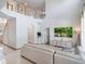 Bright living room features large windows, high ceilings, tile flooring, and a comfortable sectional sofa at 13156 Hatherton Cir, Orlando, FL 32832