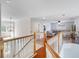 Spacious upstairs loft area with wood floors and view of the entryway at 13156 Hatherton Cir, Orlando, FL 32832