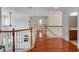 Upstairs loft area with wood floors, ceiling fan, and access to the bedrooms and bathrooms at 13156 Hatherton Cir, Orlando, FL 32832