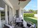 Rear patio with sliding glass doors, comfortable seating, and ceiling fan at 13156 Hatherton Cir, Orlando, FL 32832