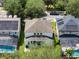 An aerial view displays the backyard, with lush green grass, patio and skylights at 13156 Hatherton Cir, Orlando, FL 32832