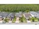 Aerial view of several homes with well-maintained lawns, driveways, and mature trees at 14078 Alafaya Oak Bnd, Orlando, FL 32828