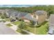 Street-level aerial view of a two-story home featuring an attached garage and manicured lawn at 14078 Alafaya Oak Bnd, Orlando, FL 32828