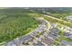 A neighborhood aerial view showing homes bordering lush woodlands at 14078 Alafaya Oak Bnd, Orlando, FL 32828