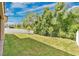 Lush backyard with green grass, mature trees, and partial privacy fence; perfect for outdoor activities at 14078 Alafaya Oak Bnd, Orlando, FL 32828