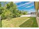 Well-kept backyard featuring a lush lawn, privacy fence, and mature trees for shade and privacy at 14078 Alafaya Oak Bnd, Orlando, FL 32828