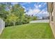 Well-manicured lawn with mature landscaping, partial fencing, and an attractive neighborhood view at 14078 Alafaya Oak Bnd, Orlando, FL 32828