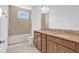 Bathroom featuring double sinks, granite countertops, and a bathtub-shower combo at 14078 Alafaya Oak Bnd, Orlando, FL 32828