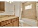 Bathroom features granite countertops, wood cabinets, a soaking tub, and tiled walls around the shower at 14078 Alafaya Oak Bnd, Orlando, FL 32828