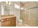 Well-lit bathroom features a granite vanity and a glass-enclosed shower, providing a functional design at 14078 Alafaya Oak Bnd, Orlando, FL 32828