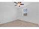 Bright bedroom featuring neutral carpet, ceiling fan, and a window providing natural light at 14078 Alafaya Oak Bnd, Orlando, FL 32828