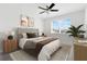 Comfortable bedroom with a ceiling fan, neutral decor, and ample natural light from the window at 14078 Alafaya Oak Bnd, Orlando, FL 32828