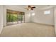 Large primary bedroom with balcony access and windows allowing plenty of natural light at 14078 Alafaya Oak Bnd, Orlando, FL 32828