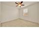Well-lit bedroom with a ceiling fan, neutral carpet, and a window providing natural light at 14078 Alafaya Oak Bnd, Orlando, FL 32828