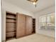 Bedroom with a built-in wall bed and shelving, and a bright window with a view at 14078 Alafaya Oak Bnd, Orlando, FL 32828
