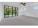 Spacious bedroom with carpet flooring, ceiling fan, and sliding glass doors to a balcony at 14078 Alafaya Oak Bnd, Orlando, FL 32828