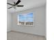Bedroom featuring neutral carpet and a large window with neighborhood views at 14078 Alafaya Oak Bnd, Orlando, FL 32828