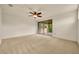 Spacious bedroom with a ceiling fan and sliding doors leading to a balcony at 14078 Alafaya Oak Bnd, Orlando, FL 32828