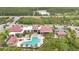 Aerial view of a resort-style community pool area, complete with lounge chairs and shaded cabanas at 14078 Alafaya Oak Bnd, Orlando, FL 32828