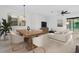 Contemporary dining and living area featuring modern decor, stylish furniture, and ample natural light at 14078 Alafaya Oak Bnd, Orlando, FL 32828