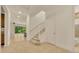 Bright entryway with staircase, tile flooring, and sliding glass doors to the backyard at 14078 Alafaya Oak Bnd, Orlando, FL 32828
