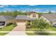 Charming two-story home with a two-car garage, manicured lawn, and inviting curb appeal at 14078 Alafaya Oak Bnd, Orlando, FL 32828
