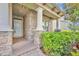 Inviting front porch with stone accents and stately columns, leading to the front door at 14078 Alafaya Oak Bnd, Orlando, FL 32828