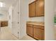 Hallway with granite countertop cabinetry, doorway, and view of the backyard through sliding glass door at 14078 Alafaya Oak Bnd, Orlando, FL 32828