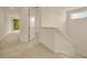 Upstairs hallway with neutral carpet and lots of natural light at 14078 Alafaya Oak Bnd, Orlando, FL 32828