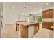Bright kitchen showcasing an island with granite countertops and dark wood cabinetry, ideal for cooking and entertaining at 14078 Alafaya Oak Bnd, Orlando, FL 32828