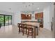 Open kitchen with an island, granite countertops, stainless steel appliances, and plentiful storage at 14078 Alafaya Oak Bnd, Orlando, FL 32828