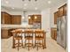 Kitchen with dark wood cabinets, granite countertops, stainless steel appliances, and a kitchen island at 14078 Alafaya Oak Bnd, Orlando, FL 32828