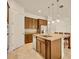 Kitchen with dark wood cabinets, granite countertops, stainless steel appliances, and a large island at 14078 Alafaya Oak Bnd, Orlando, FL 32828