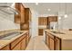 Kitchen with granite countertops, stainless steel appliances, dark wood cabinets, and a modern cooktop at 14078 Alafaya Oak Bnd, Orlando, FL 32828