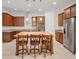 Bright, spacious kitchen with stainless steel appliances, island with seating, and ample counter space at 14078 Alafaya Oak Bnd, Orlando, FL 32828