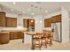 Spacious kitchen with dark wood cabinets, granite countertops, stainless steel appliances, and a large island at 14078 Alafaya Oak Bnd, Orlando, FL 32828