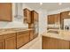 Kitchen featuring granite countertops, dark wood cabinets, stainless steel appliances, and a cooktop at 14078 Alafaya Oak Bnd, Orlando, FL 32828