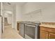 Laundry room with washer, dryer, shelving, granite counters and view of staircase at 14078 Alafaya Oak Bnd, Orlando, FL 32828