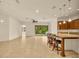 Open-concept living area with tile flooring and access to a screened patio at 14078 Alafaya Oak Bnd, Orlando, FL 32828