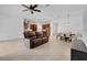 Open-concept living room featuring tile flooring and a comfortable leather sofa at 14078 Alafaya Oak Bnd, Orlando, FL 32828