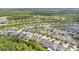Aerial view showcasing a vibrant neighborhood with well-maintained homes and scenic water features at 14078 Alafaya Oak Bnd, Orlando, FL 32828