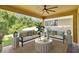 Inviting covered patio featuring comfortable seating and a ceiling fan for relaxing outdoors at 14078 Alafaya Oak Bnd, Orlando, FL 32828