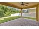Covered patio with brick flooring, ceiling fan, and views of the fenced yard at 14078 Alafaya Oak Bnd, Orlando, FL 32828